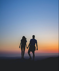 What's happiness in life - couple walking toward sunset